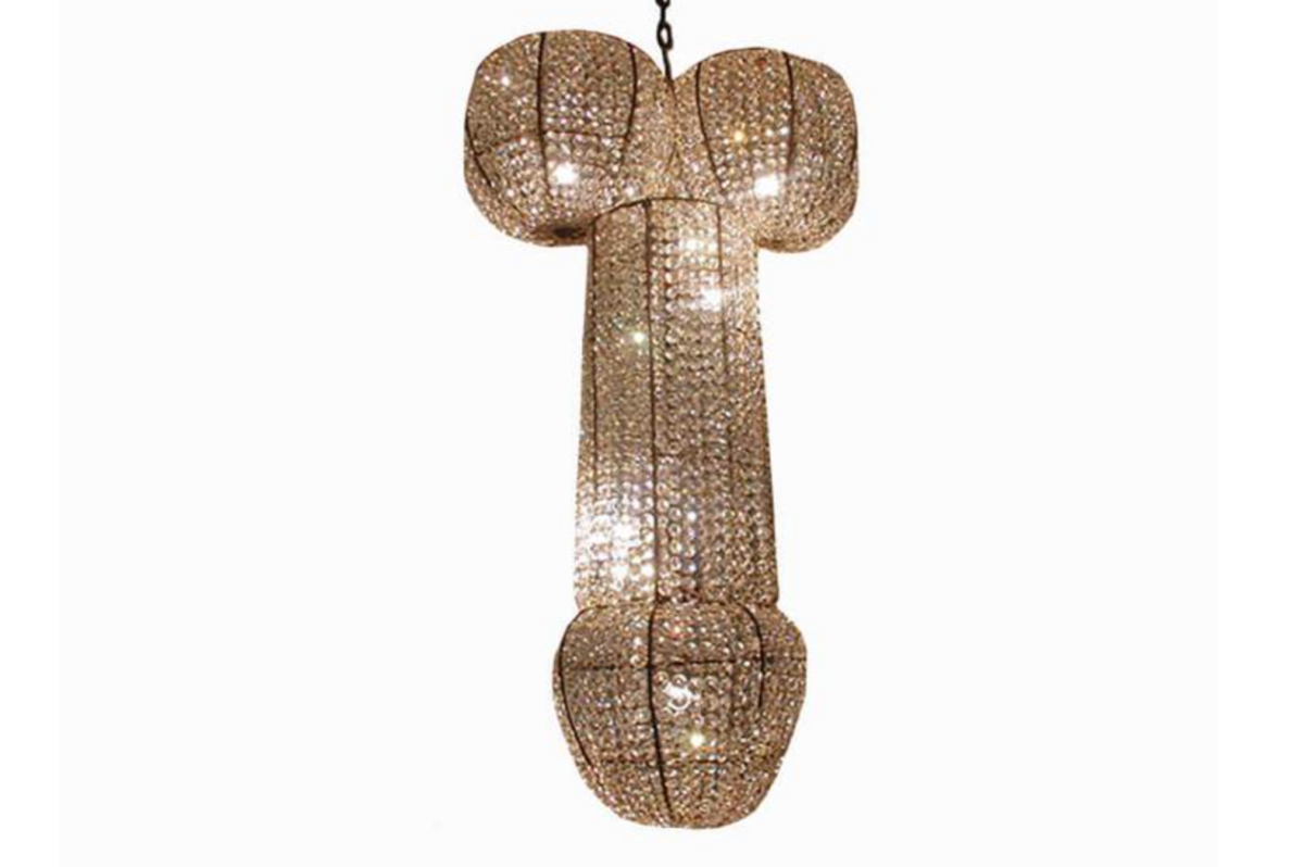 A glowing cock-shaped chandelier symbolizing the power of sexual healing for men