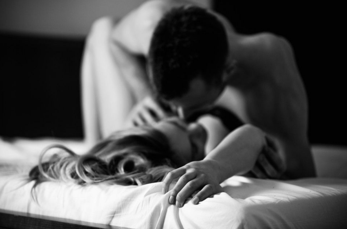 man on top of a woman sharing intimate moment