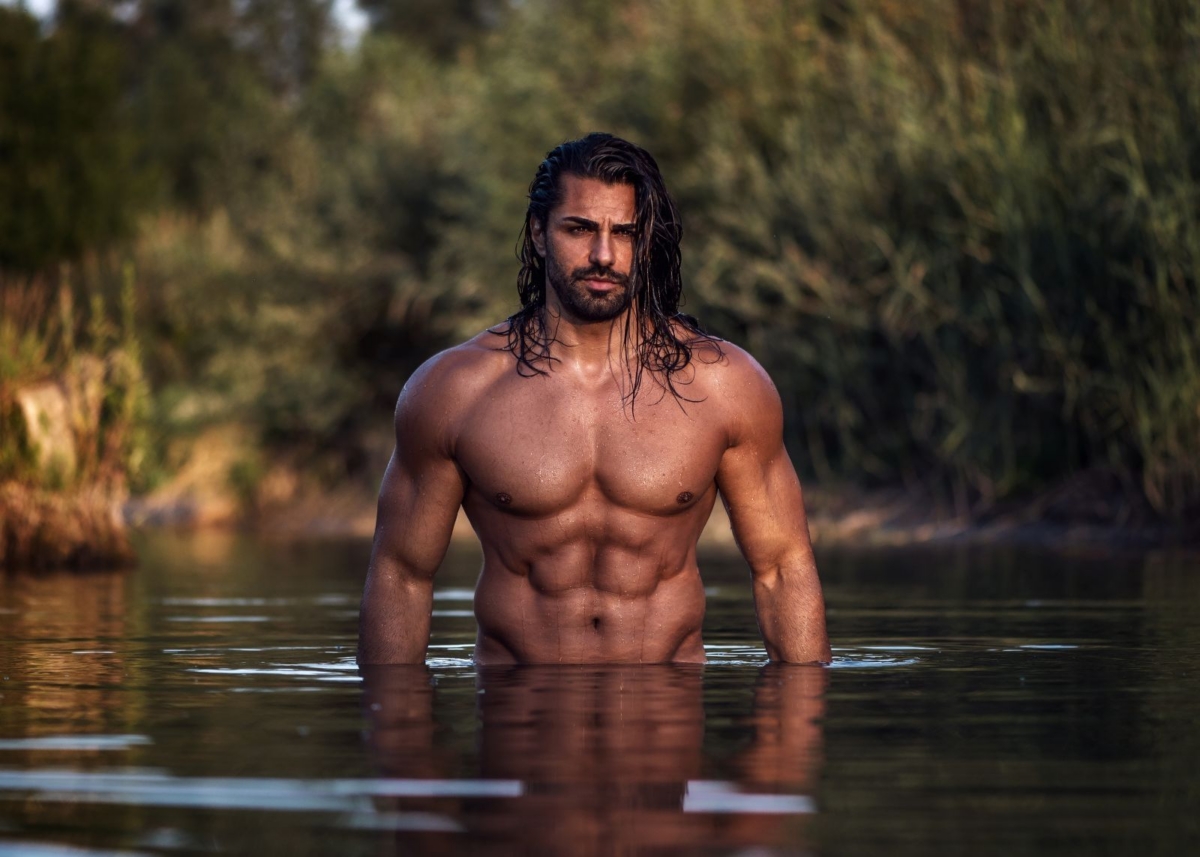 muscular man in water in nature